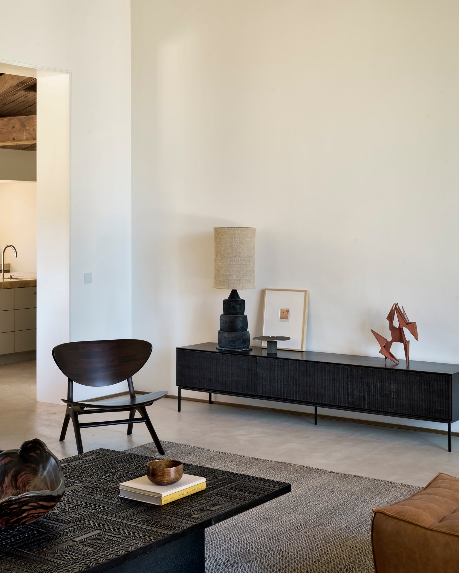 Eye-lounge-chair-dark-brown-Tabwa-coffee-table-Grooves-TV-cupboard-N701-footstool-old-saddle-Checked-kilim-rug-Goode-Studio