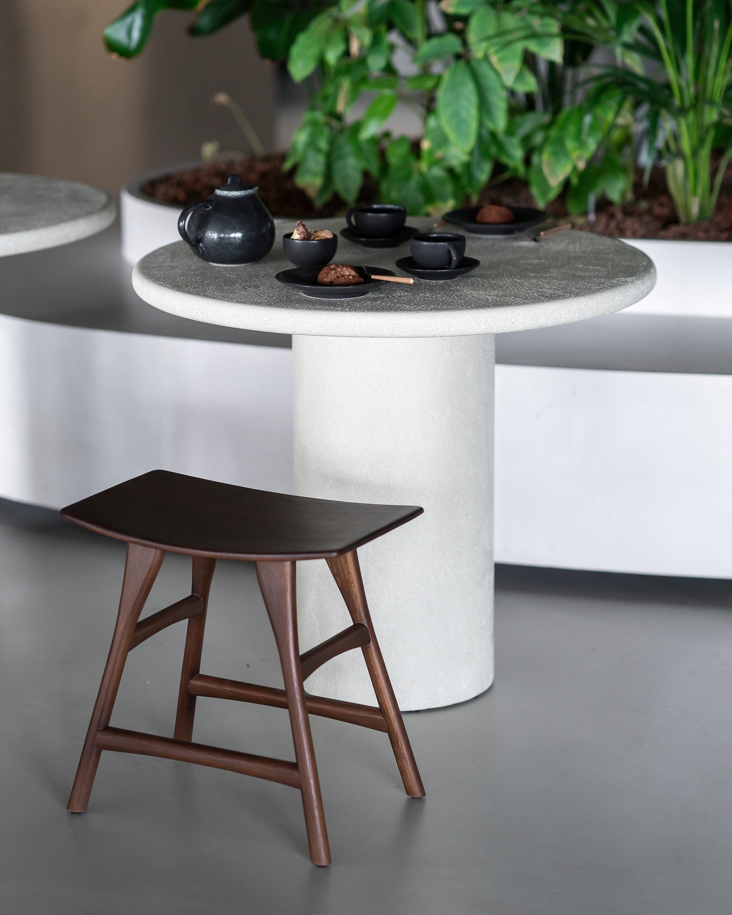 Microcement round dining table off white for commercial dining space
