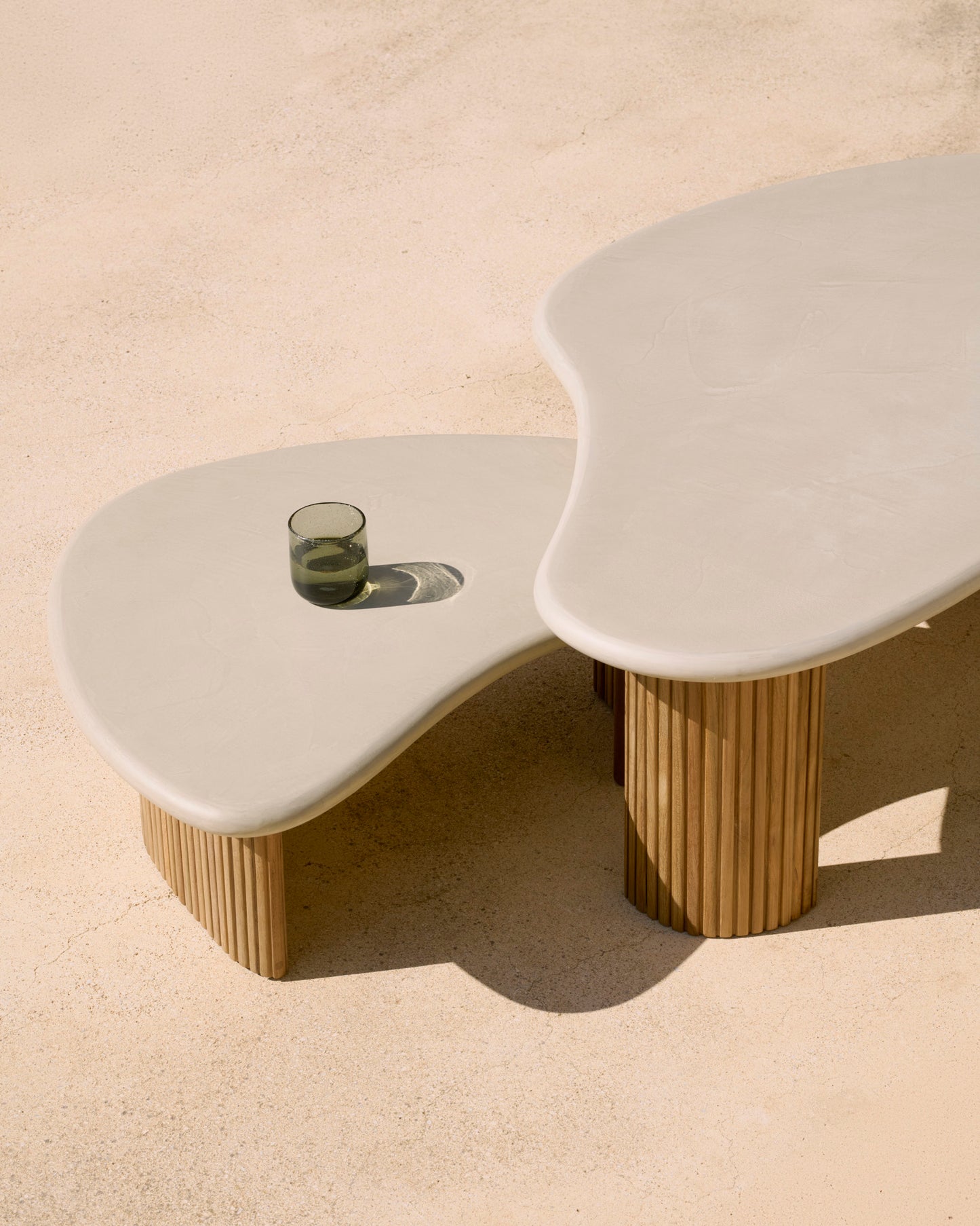Boomerang-outdoor-coffee-table-concrete-top-reclaimed-teak-base-pebble-shape-Goode-Studio