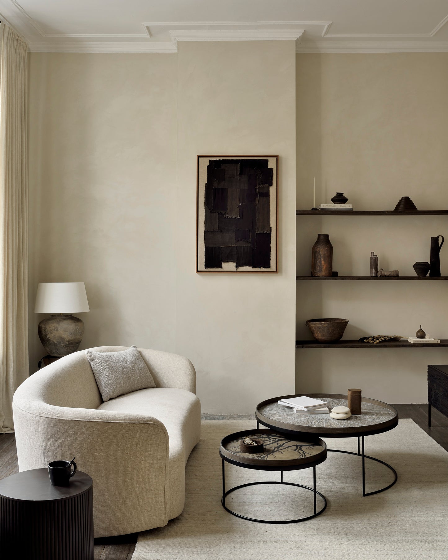 Sand-Nomad-kilim-rug-tray-Round-tray-coffee-table-set-Ellipse-sofa-oatmeal-Oat-Nomad-cushion-Mahogany-Roller-Max-dark-brown-round-side-table-Goode-Studio