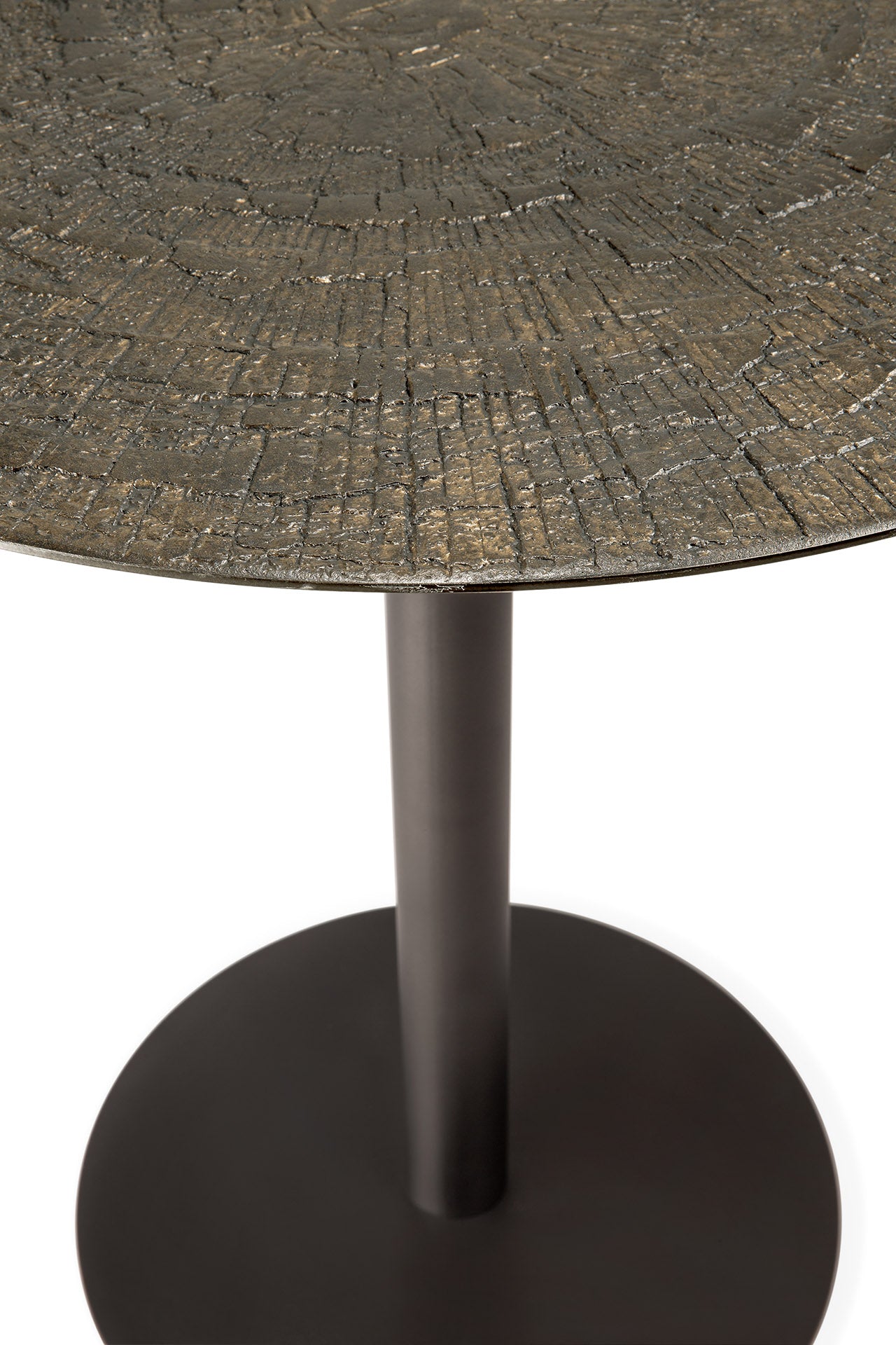 Close-up of a table with a textured top and dark bronze base.