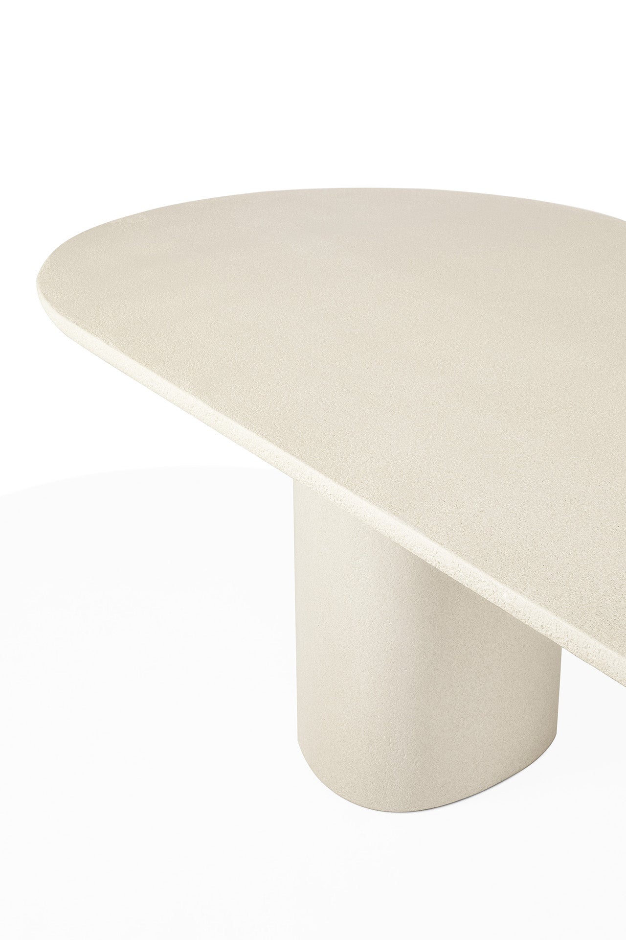 Contemporary stone finish dining table with sculptural silhouette
