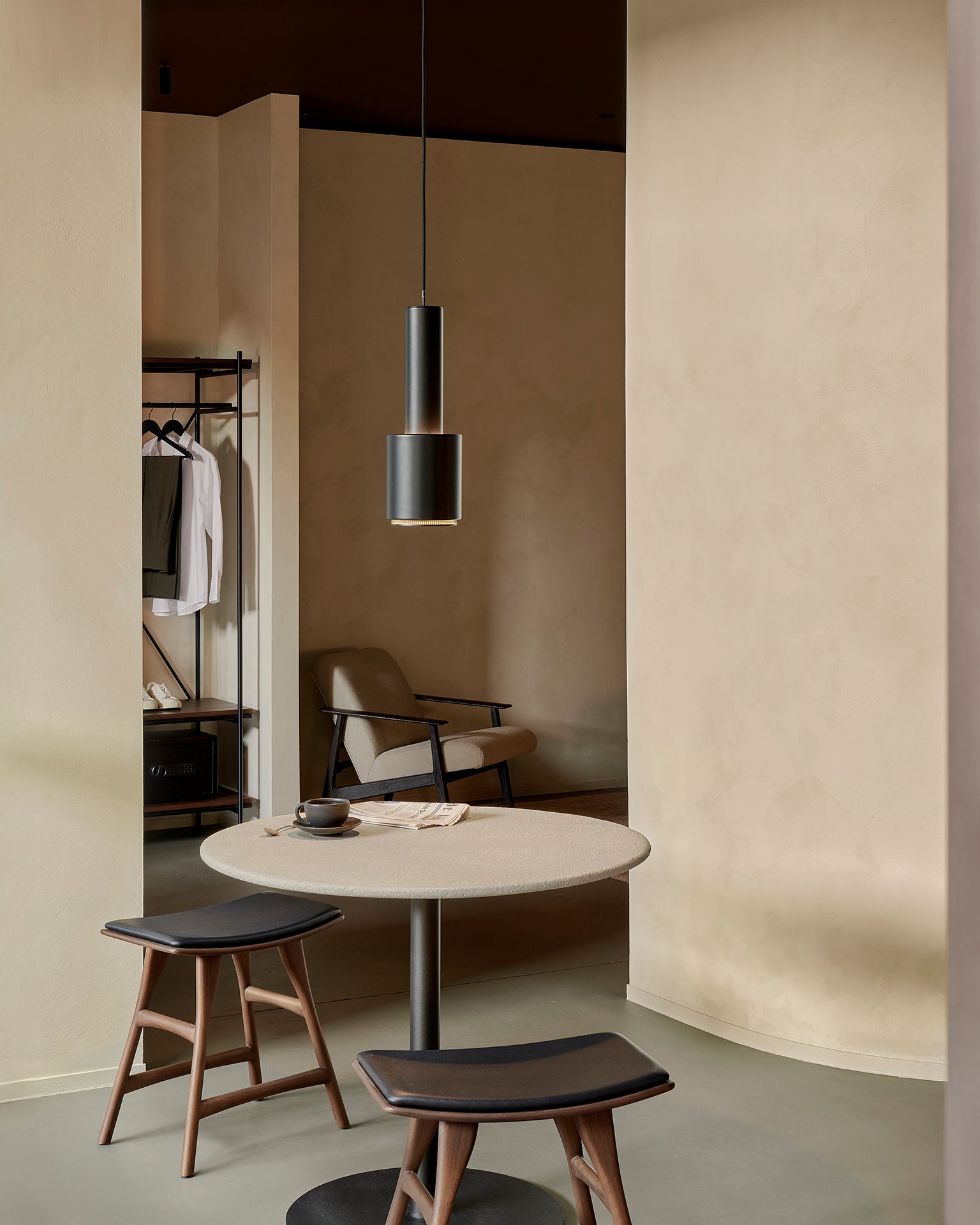 Blend-dining-table-Off-White-top-round-Dark-Bronze-base-Osso-stool-Brown-frame-Black-Leather-cushion-Goode-Studio