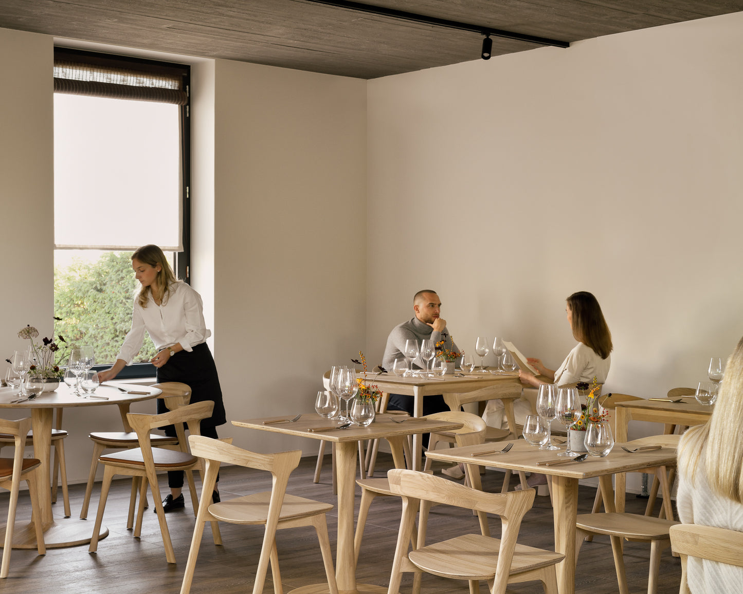 Rectangular solid wood dining table for hospitality seating

