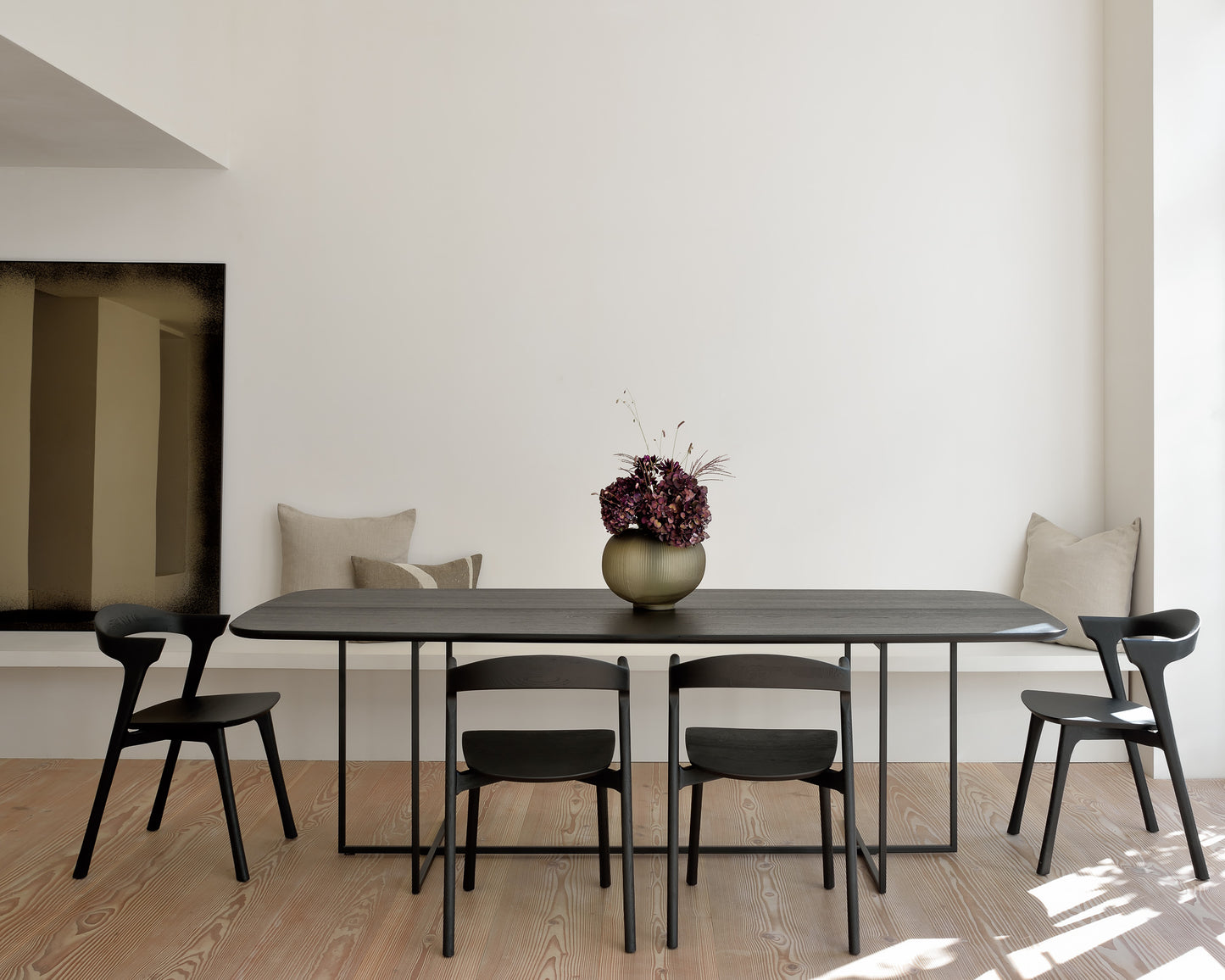 Oak-Arc-black-dining-table-Oak-Bok-black-dining-chair-Bronze-wall-mirror-cushions-Goode-Studio