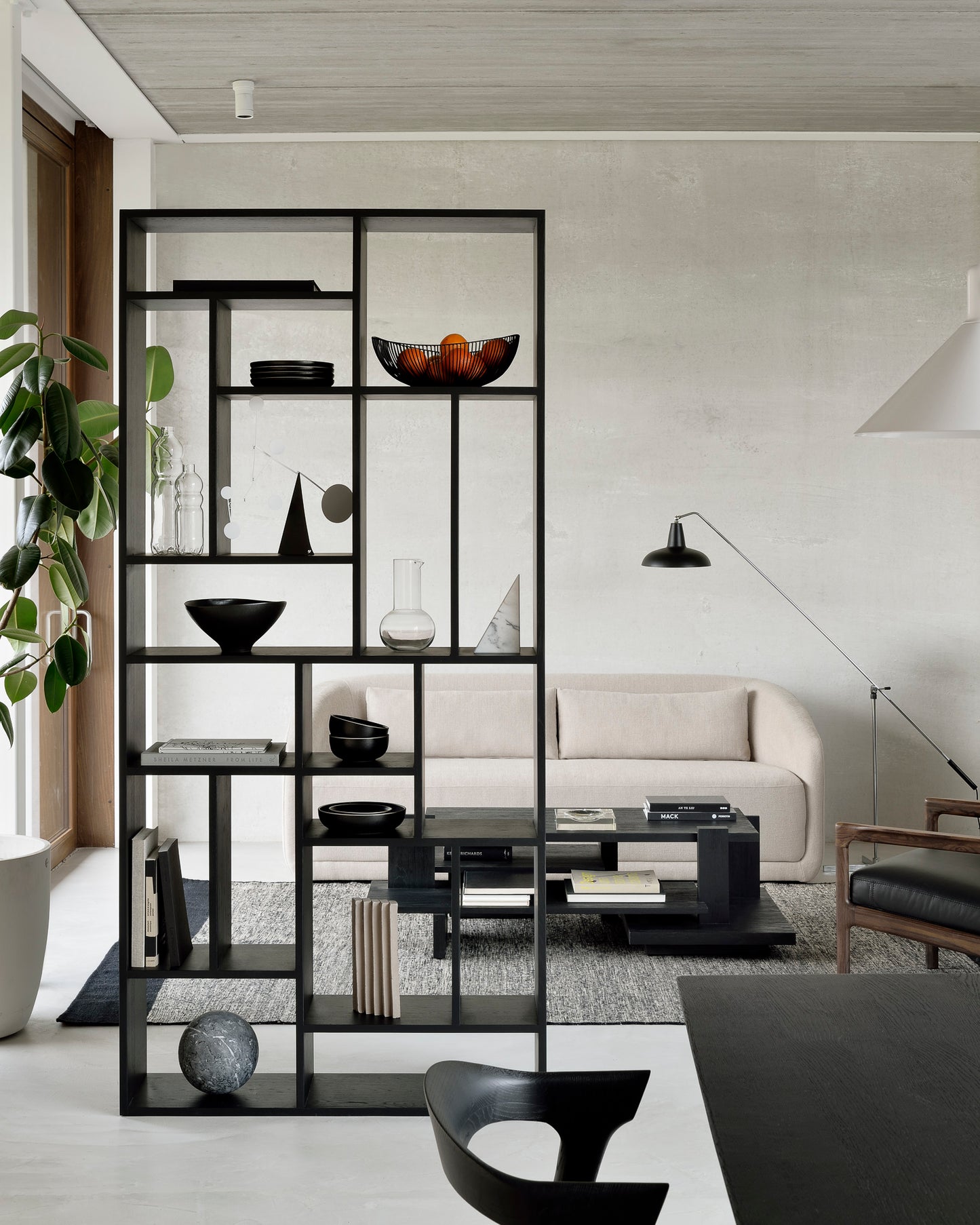 Oak-M-black-rack-Teak-Abstract-black-coffee-table-Trapeze-sofa-3-seater-beige-Lumbar-cushions-beige-Black-Dots-kilim-rug-Goode-Studio