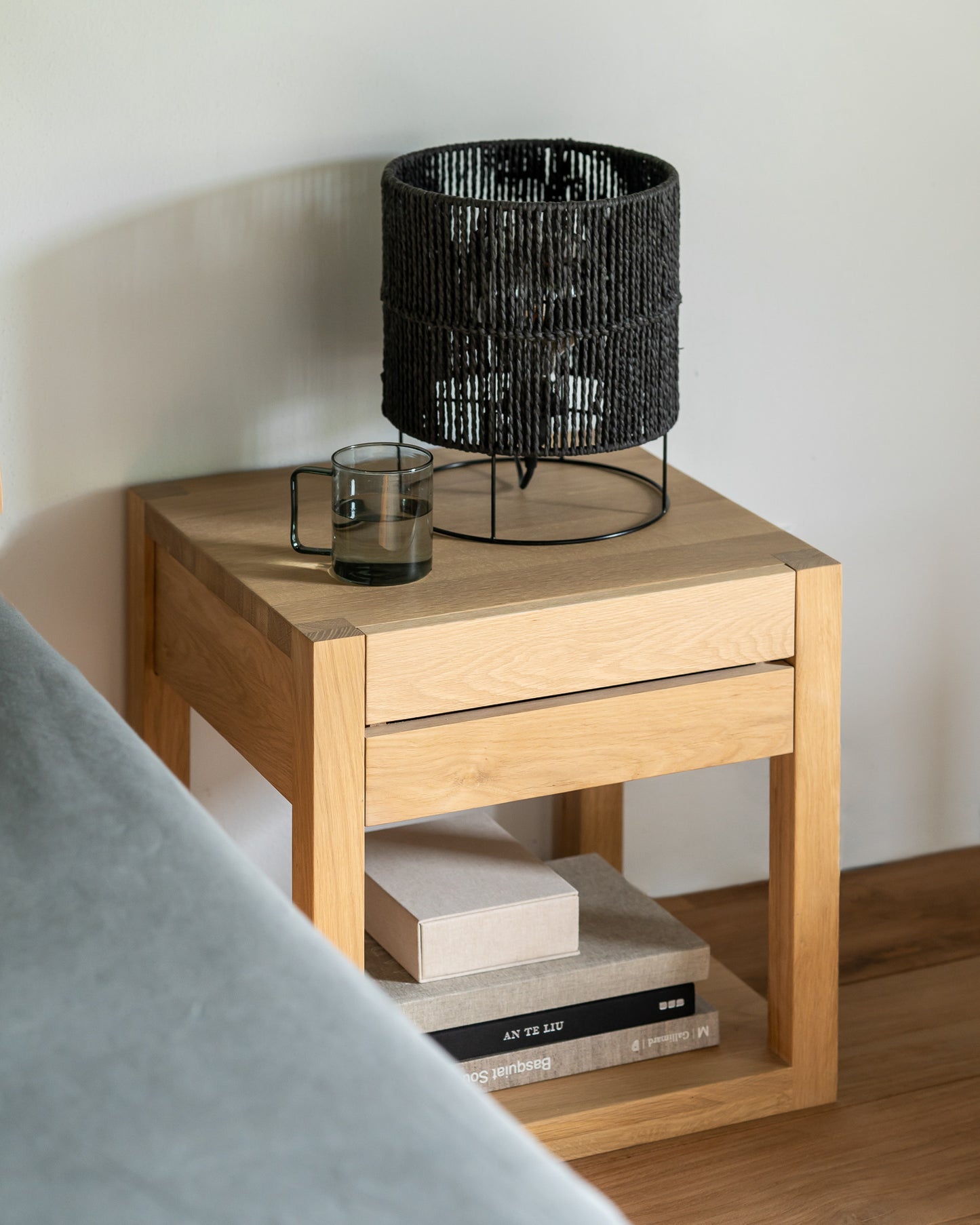Natural oak bedside table for contemporary bedroom design
