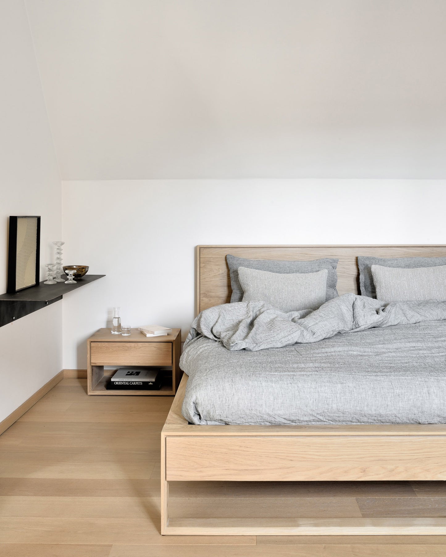 Floating oak bedside table for minimalist bedroom
