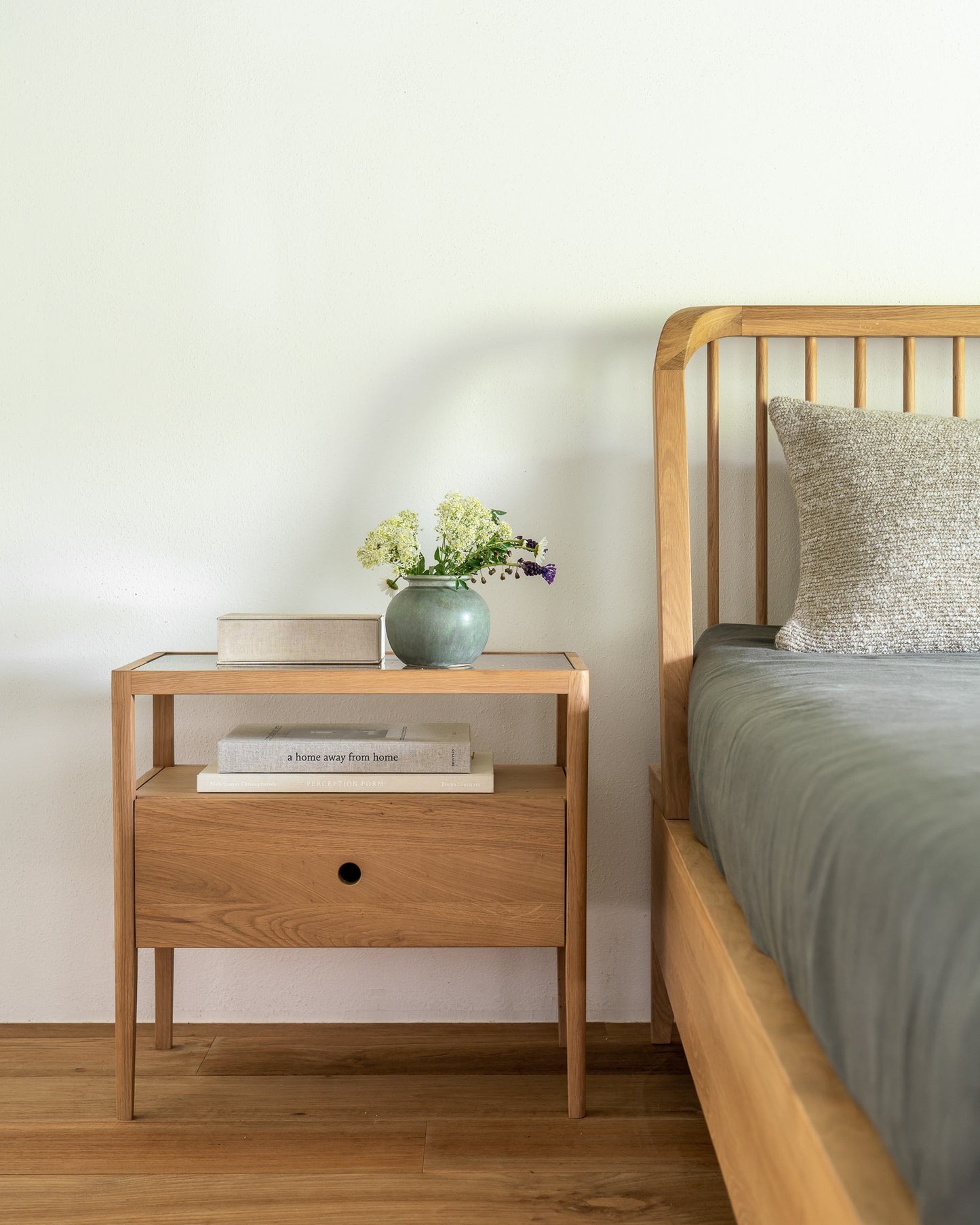 Compact spindle bedside table with open storage shelf
