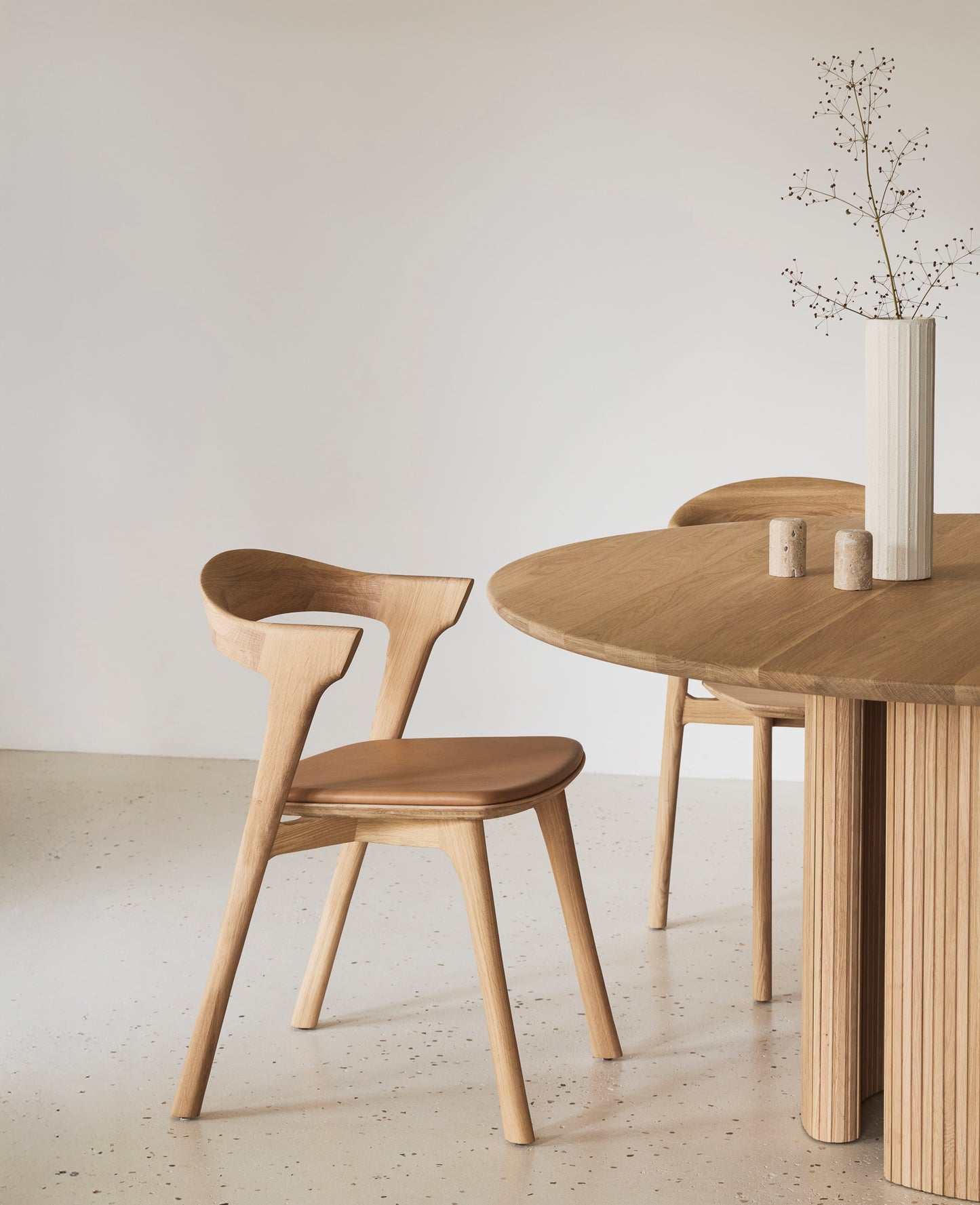 Roller Max dining table stacked wood stick sculptural base
