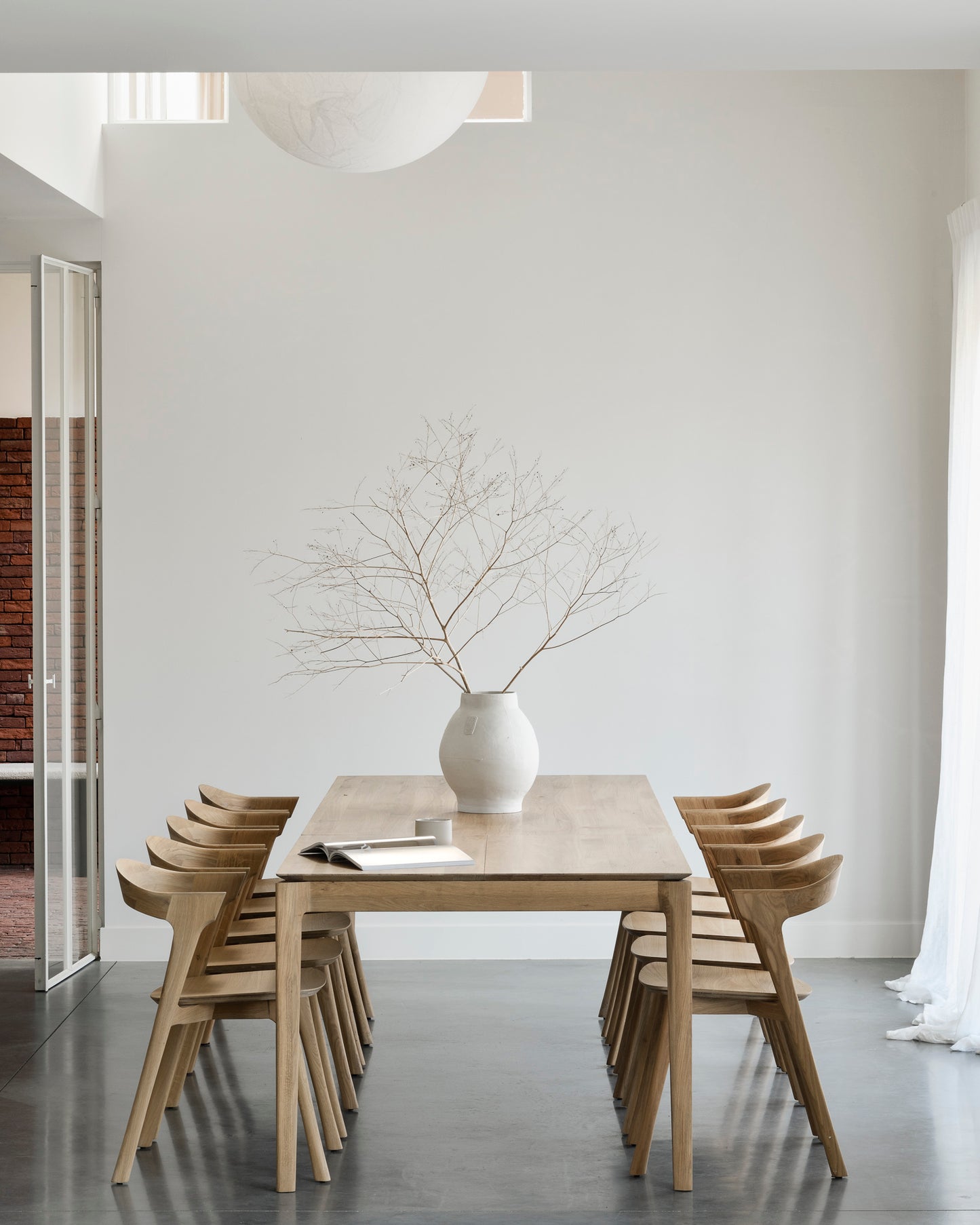 Bok extendable dining table in solid oak with expandable seating and sculptural design