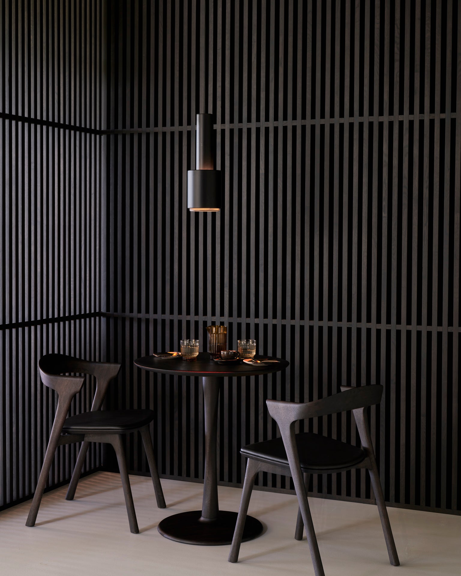 Bok-dining-chair-brown-frame-black-leather-cushion-torsion-dining-table-brown-Goode-Studio