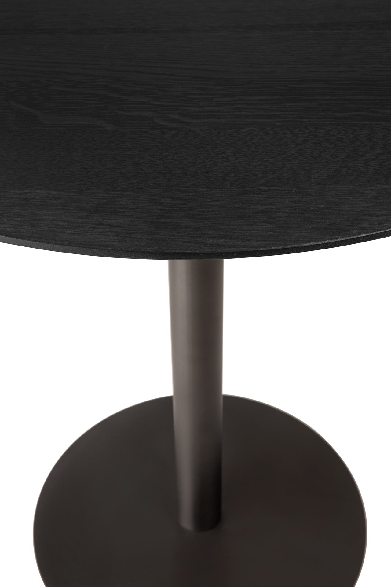 Close-up of a black table with a round top and base.