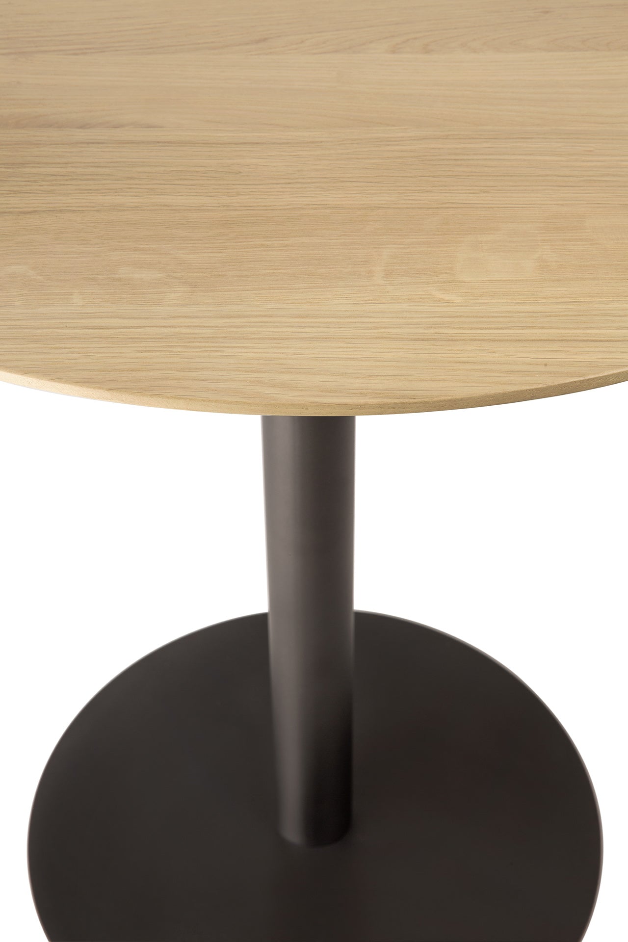 Close-up of a round oak table with a bronzebase on a white background