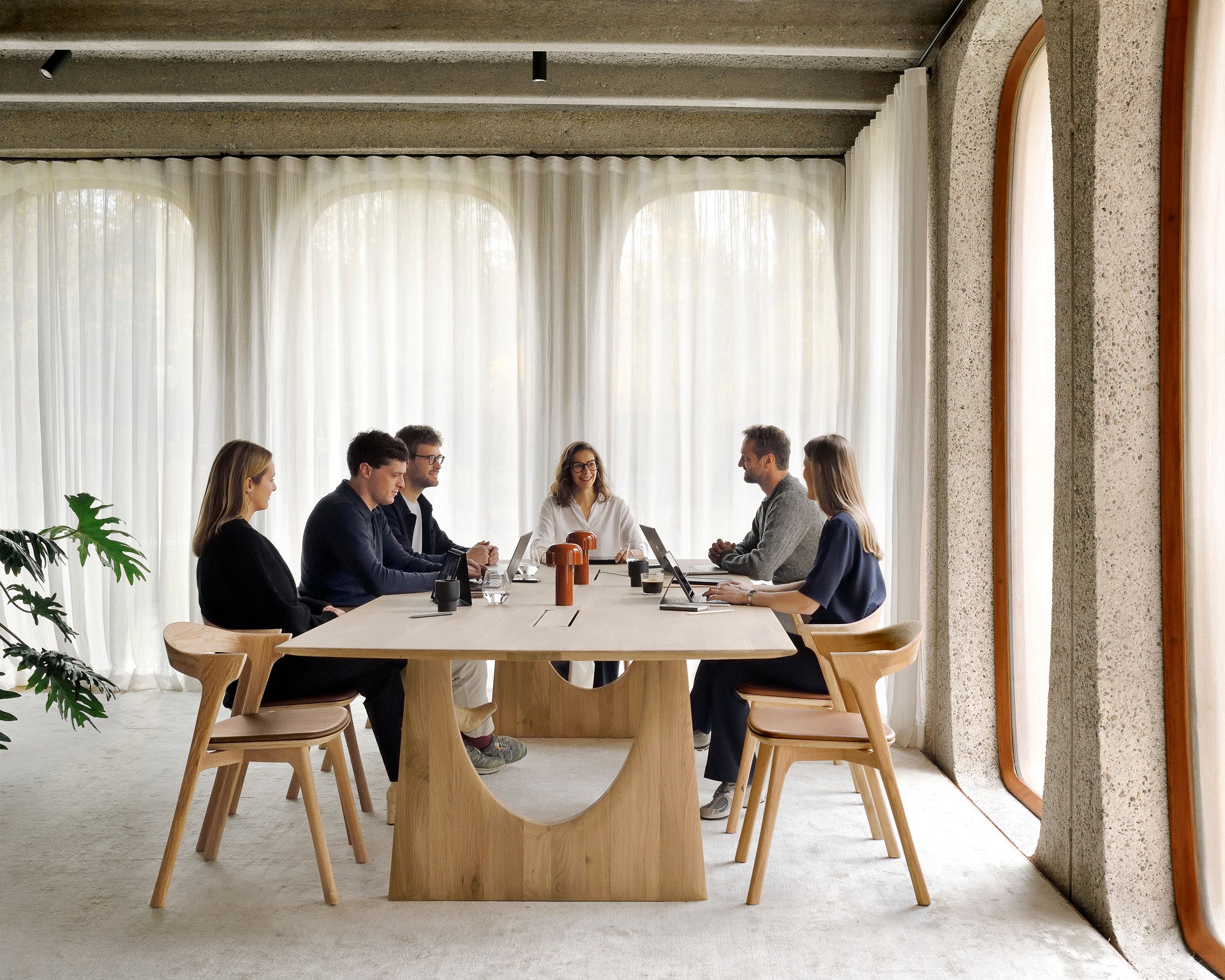 Geometric-meeting-table-Bok-dining-chair-oak-cognac-leather-Aged-mirror-tray-people-hor-Goode-Studio